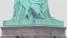 Statue of Liberty evacuated after woman climbed monument base