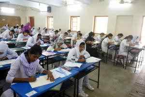 Students writing their answer scripts in one of the HSC examination halls at the Viqarunnisa Noon School and College in the capital on Sunday, the first day of the examinations. Over 1.2 million students are sitting for the exam this year. Photo: bbarta24.net.