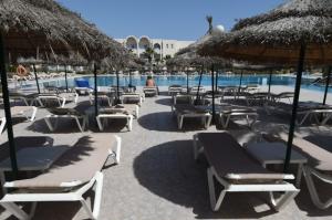 A tourist sits on a sunbed next to a hotel pool on the Tunisian resort island of Djerba on May 26, 2016. Before the 2011 revolution, the annual number of visitors in Tunisia reached nearly seven million, with tourism accounting for some 7 per cent of the gross domestic product (GDP). AFP Photo