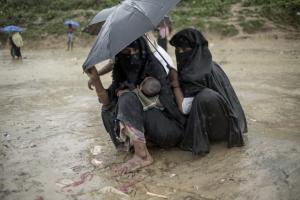 Rohingya Muslim refugees take shelter from the rain at Balukhali refugee camp in Bangladesh\'s Ukhia district on October 7, 2017. A top UN official said Saturday Bangladesh\'s plan to build the world\'s biggest refugee camp for 800,000-plus Rohingya Muslims was dangerous because overcrowding could heighten the risks of deadly diseases spreading quickly. AFP Photo